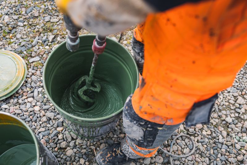 worker mixing epoxy floor mixture