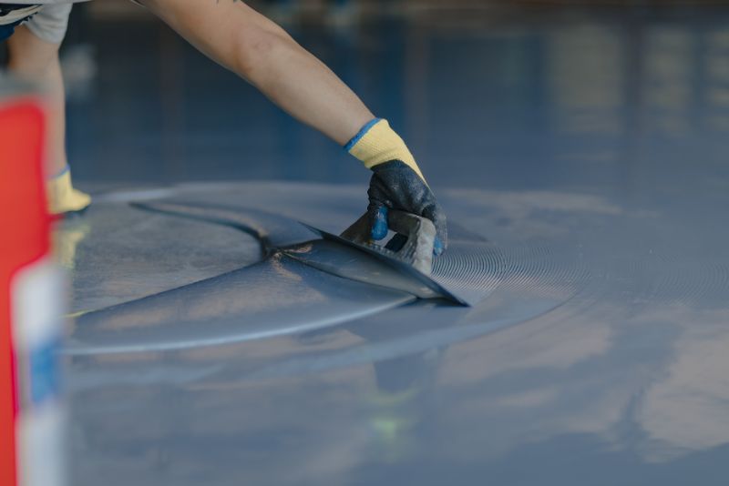 Epoxy floor mixture being levelled during installation