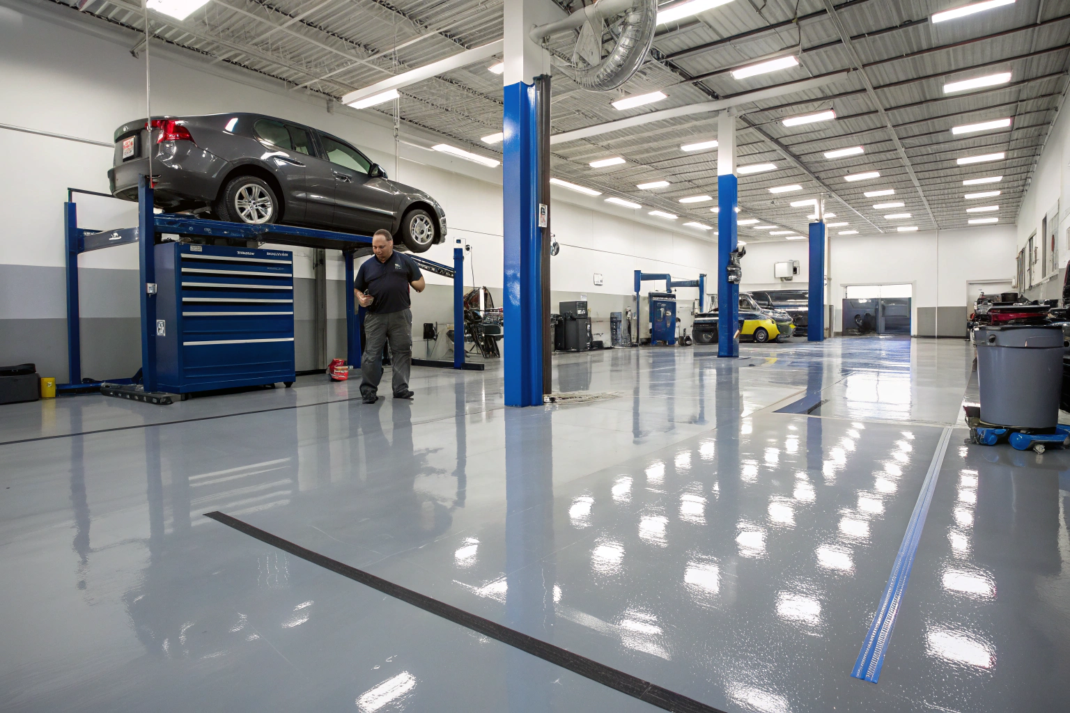 Automotive repair shop interior with epoxy-coated flooring